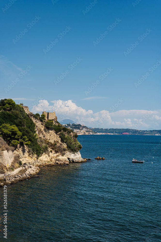The rocky coast in the south of Italy, the city of Baia. Calm beautiful sea panorama of the Tyrrhenian Sea