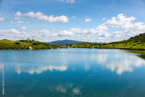 blue sky reflection in the water surface of a mountain lake