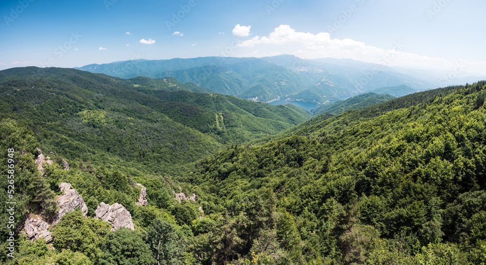 Landscape scenery with forested hills and water reservoir down in the valley. View from above. Landscape scenery with forested hills and water reservoir down in the valley. View from above.