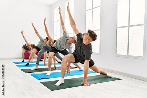 Group of young hispanic people concentrate training at sport center.