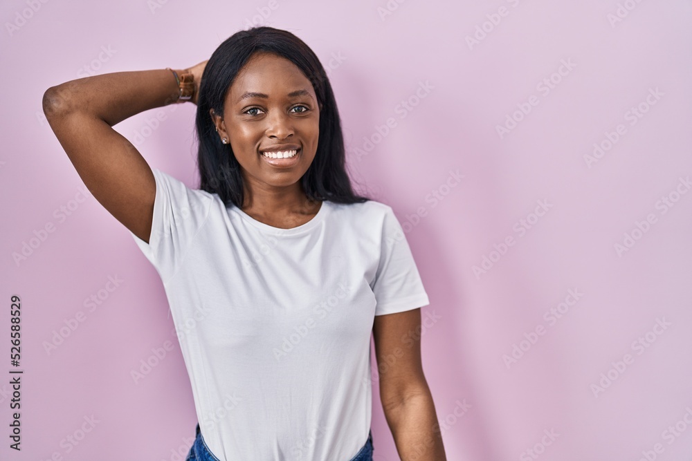 African young woman wearing casual white t shirt smiling confident touching hair with hand up gesture, posing attractive and fashionable African young woman wearing casual white t shirt smiling confident touching hair with hand up gesture, posing attractive and fashionable