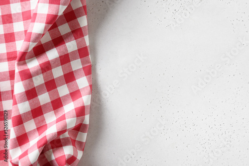 Kitchen white table with red checkered towel. Top view. Flat lay. Space for your design, recipe or menu.