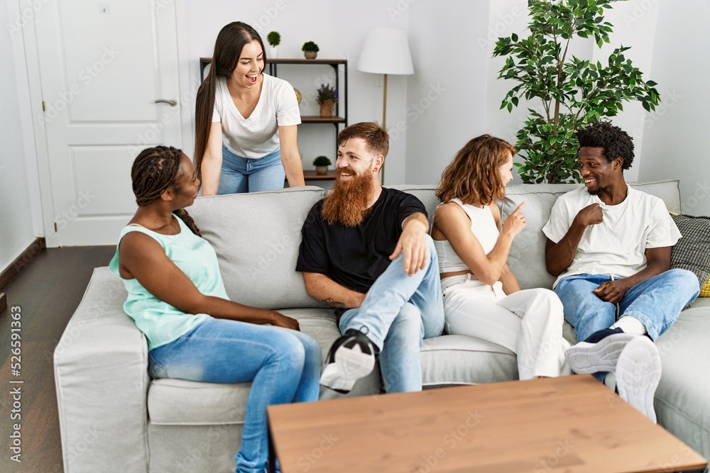 Group of young friends smiling happy sitting on the sofa at home. Group of young friends smiling happy sitting on the sofa at home.