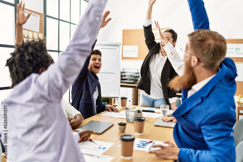 Fototapeta premium Group of business workers smiling happy celebrating with hands together at the office.