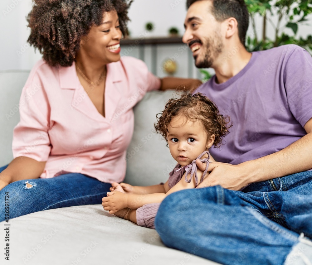 Couple and daughter smiling confident sitting on sofa at home Couple and daughter smiling confident sitting on sofa at home