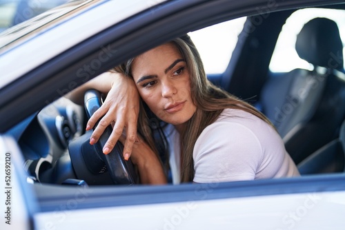 Young woman driving car at street