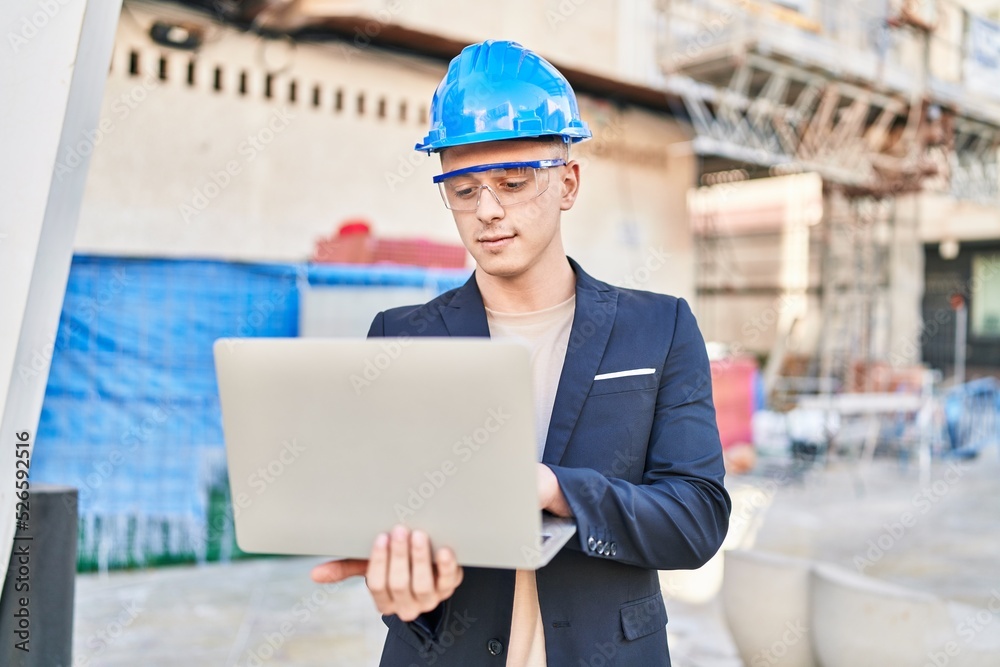 Young hispanic man architect using laptop at street Young hispanic man architect using laptop at street