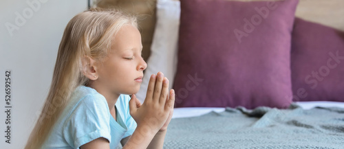 Little girl praying at home