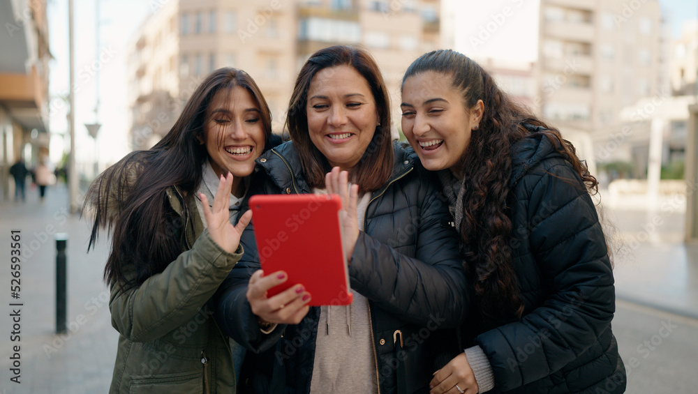 Mother and daugthers having video call hugging each other at street Mother and daugthers having video call hugging each other at street