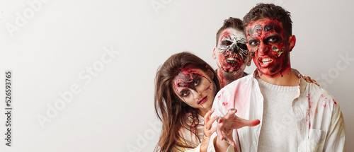 Fotografija Scary zombies on light background with space for text
