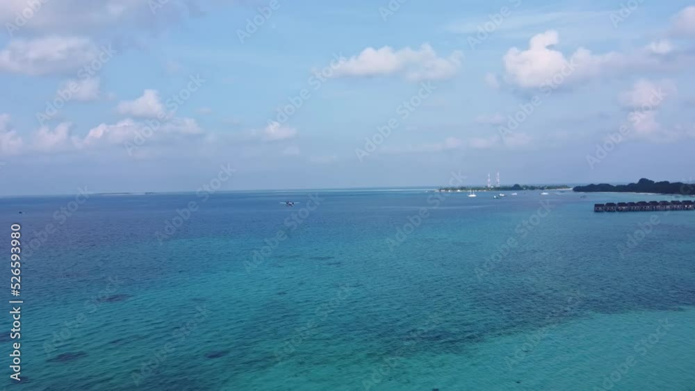 the island in the ocean with a white sandy beach and villas on the water the island in the ocean with a white sandy beach and villas on the water