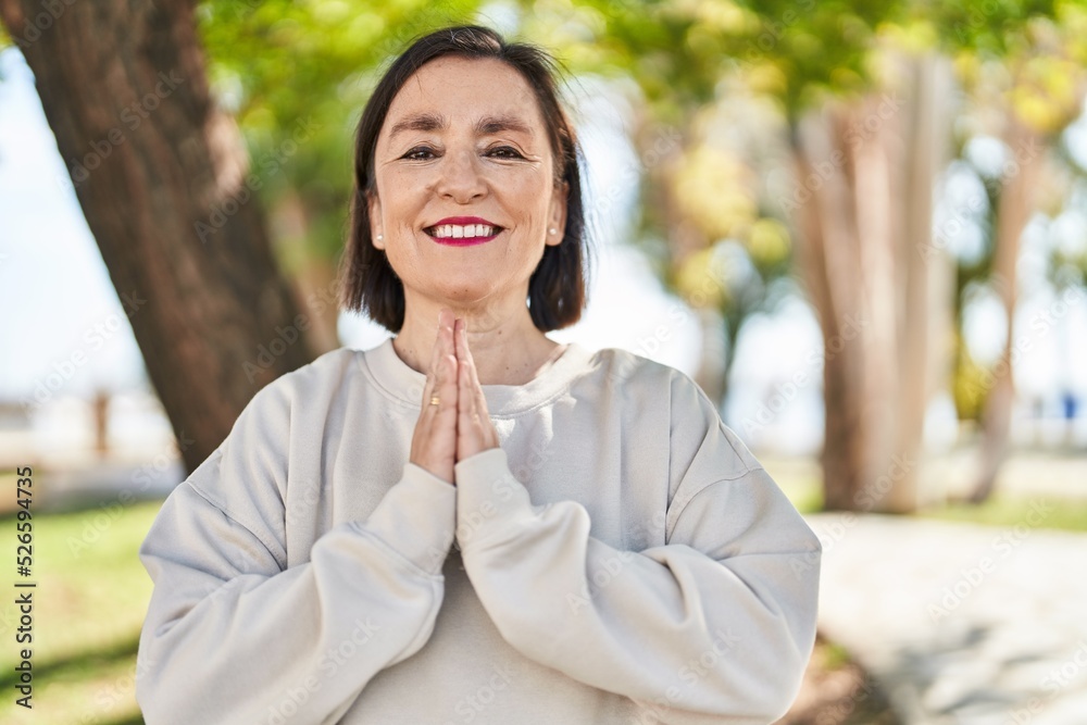 Middle age woman smiling confident training yoga at park Middle age woman smiling confident training yoga at park