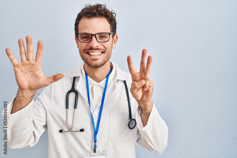 Young hispanic man wearing doctor uniform and stethoscope showing and pointing up with fingers number eight while smiling confident and happy. Young hispanic man wearing doctor uniform and stethoscope showing and pointing up with fingers number eight while smiling confident and happy.