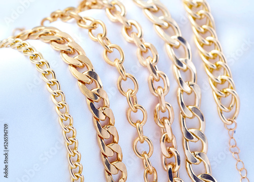 Gold  jewelry. Gold chains on background