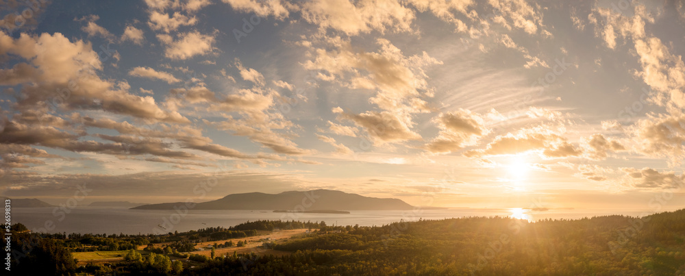 Sunset View of Orcas Island, Washington. A beautiful aerial look at a summer cloudscape over Orcas island in the San Juan Islands and the Salish Sea as seen from Lummi Island.