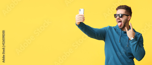 Cool young man taking selfi...