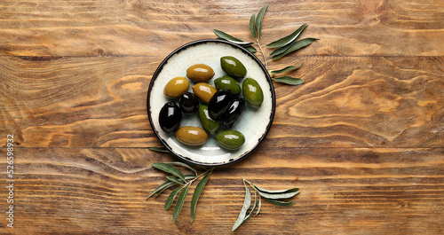 Fototapeta Naklejka Na Ścianę i Meble -  Plate with delicious olives on wooden background