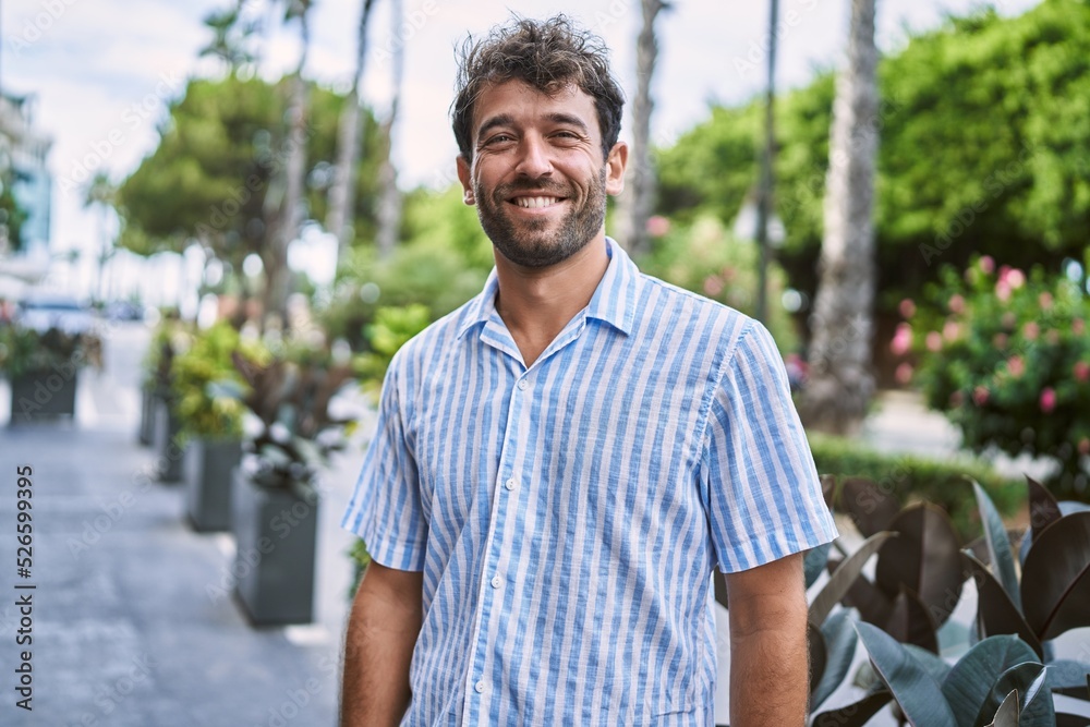 Young hispanic man smiling happy standing at the city. Young hispanic man smiling happy standing at the city.