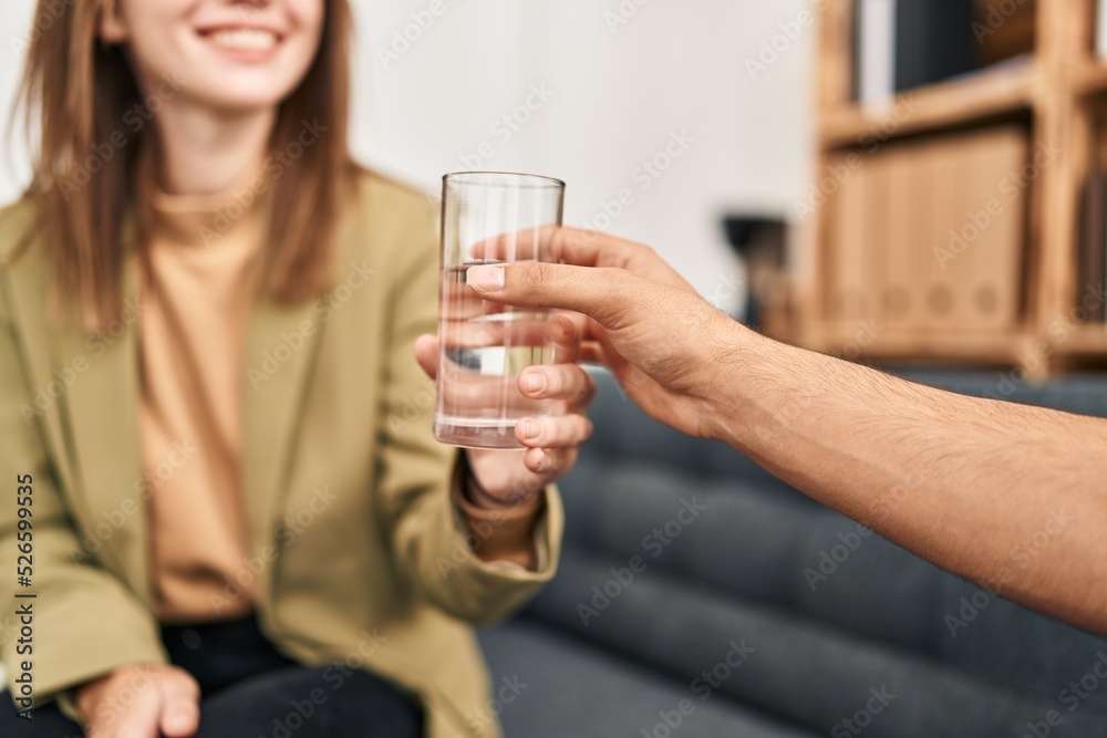 Man and woman having psychology session drinking water at psychology center Man and woman having psychology session drinking water at psychology center