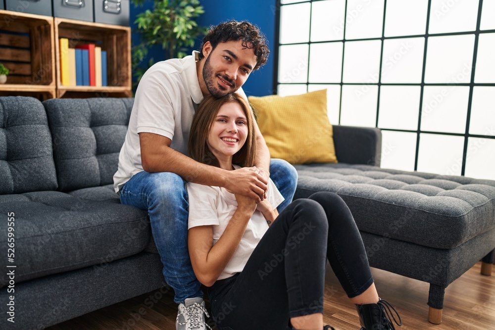 Obraz premium Man and woman smiling confident hugging each other at home