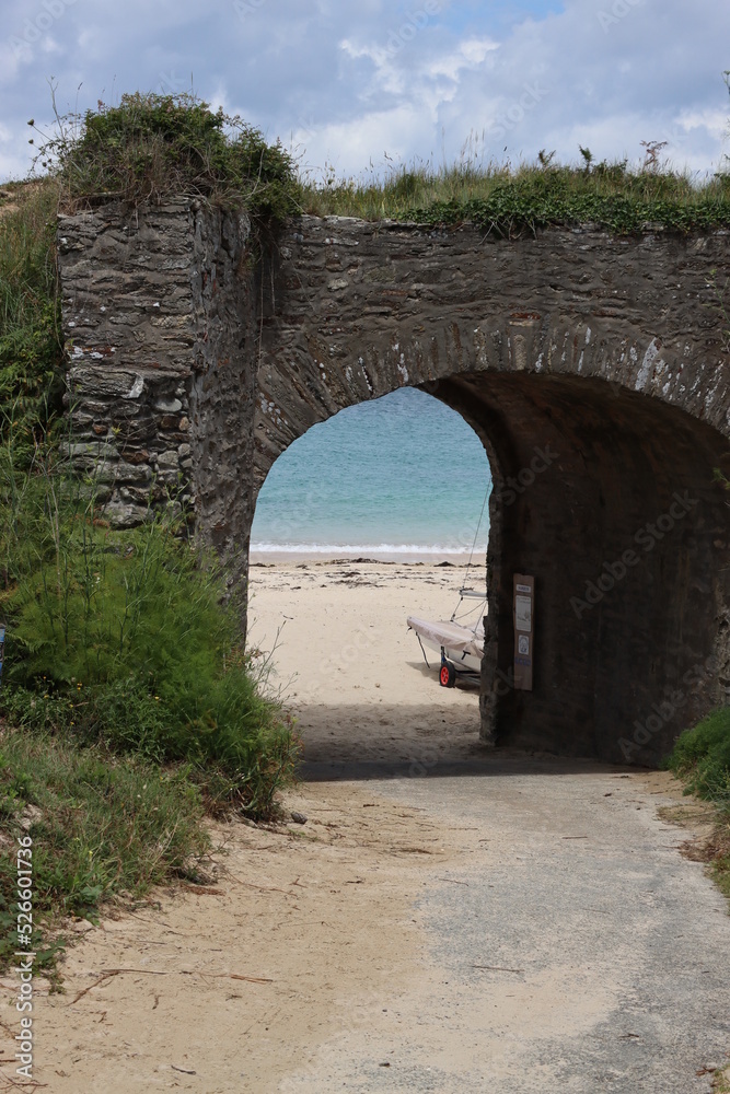 old stone bridge in front of the beach 