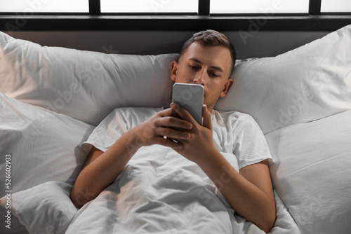 Young man using mobile phon...