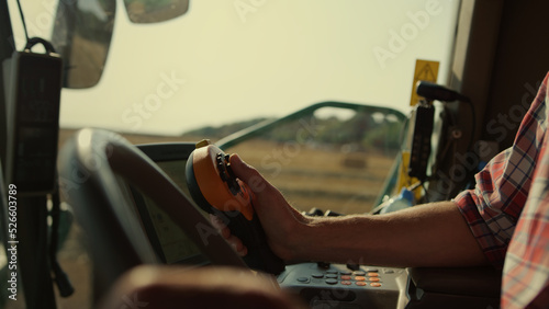 Farmer hands driving harvester closeup. Tractor operator controlling machinery