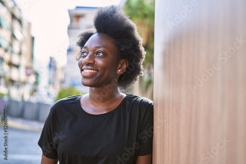 Young african woman smiling confident at street