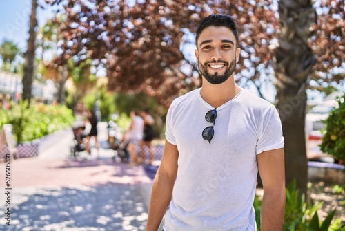 Young arab man smiling happy standing at the city.