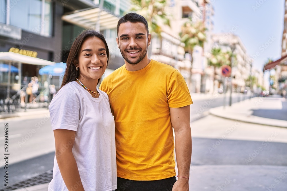 Young latin couple smiling happy and hugging standing at the city. Young latin couple smiling happy and hugging standing at the city.