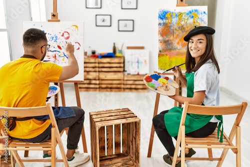 Fotografía Young hispanic couple smiling happy drawing at art studio.