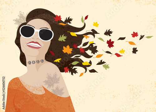 An attractive smiling woman on grunge background, with sunglasses and fall leaves in her hair
