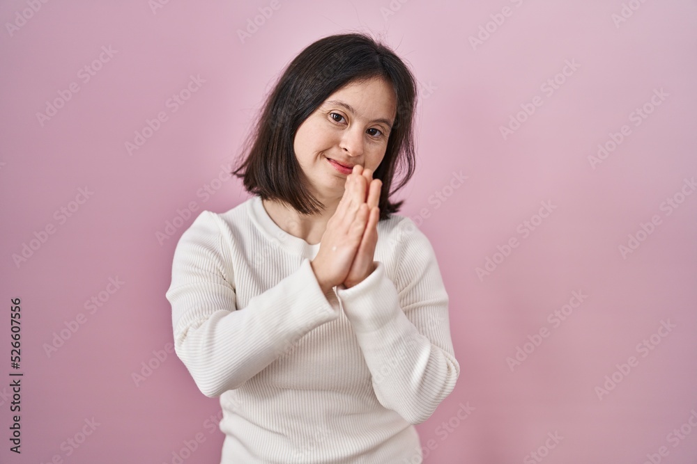 Woman with down syndrome standing over pink background clapping and applauding happy and joyful, smiling proud hands together Woman with down syndrome standing over pink background clapping and applauding happy and joyful, smiling proud hands together