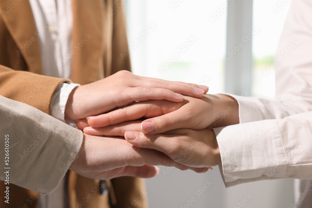 Group of people holding hands together indoors, closeup. Unity concept Group of people holding hands together indoors, closeup. Unity concept
