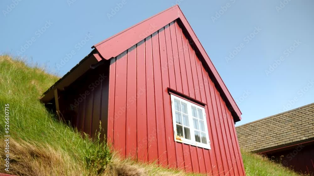 Parliament buildings in Tinganes, Torshavn, Faroe Islands. Grass rooftop with a window in a red buidling. Grass covered house. Typical scandinavian architecture in Torshavn. High quality 4k footage Parliament buildings in Tinganes, Torshavn, Faroe Islands. Grass rooftop with a window in a red buidling. Grass covered house. Typical scandinavian architecture in Torshavn. High quality 4k footage