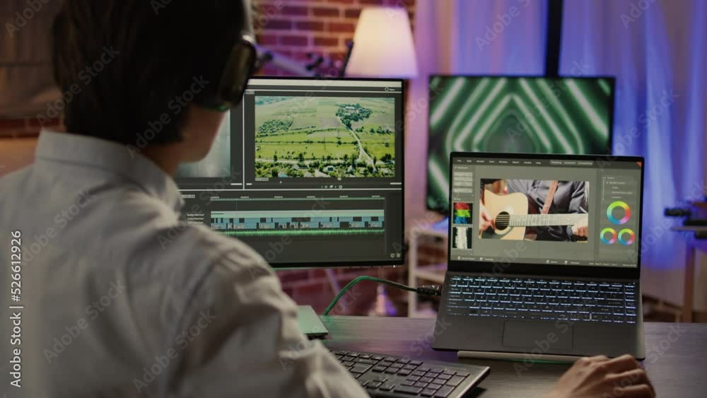 Media colorist editing video montage on visual effects software, using color grading for film and sound in post production house. Movie footage edit with artistic tools. Handheld shot.