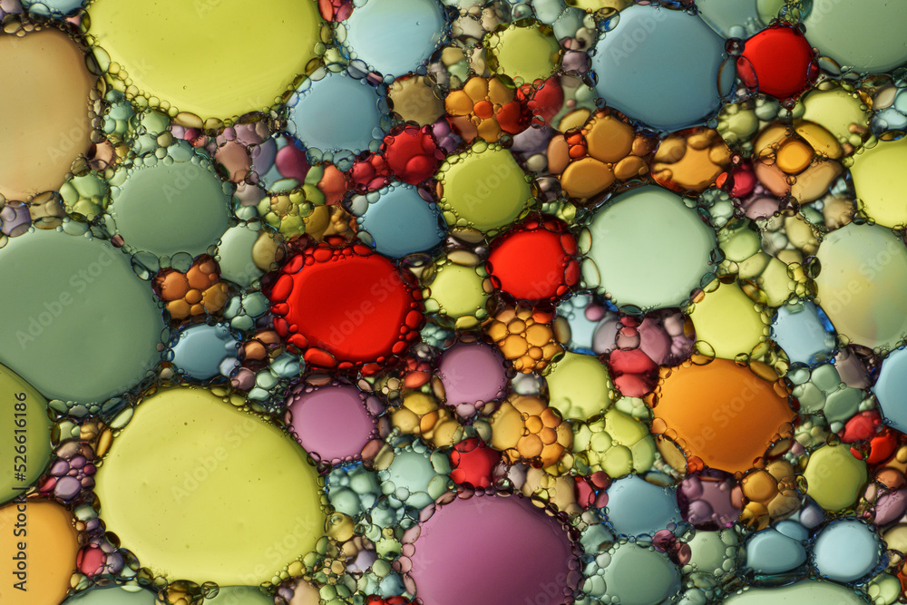 Vivid macro image of colorful oil drops on water Vivid macro image of colorful oil drops on water
