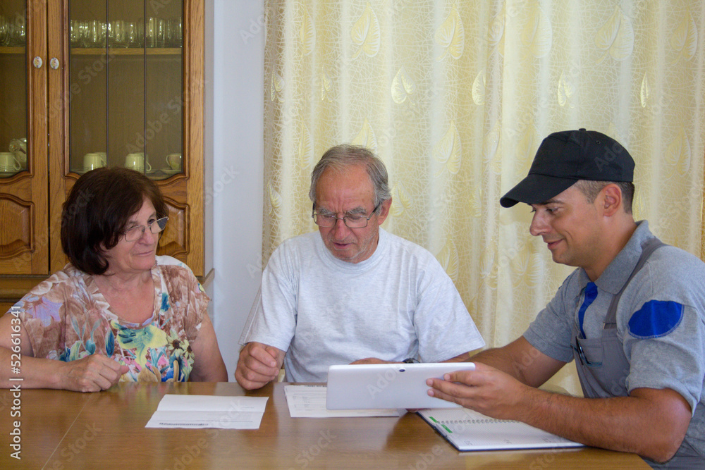 Image of an elderly couple checking documents and bills of a construction worker for home renovation work.
Image of an elderly couple checking documents and bills of a construction worker for home renovation work.