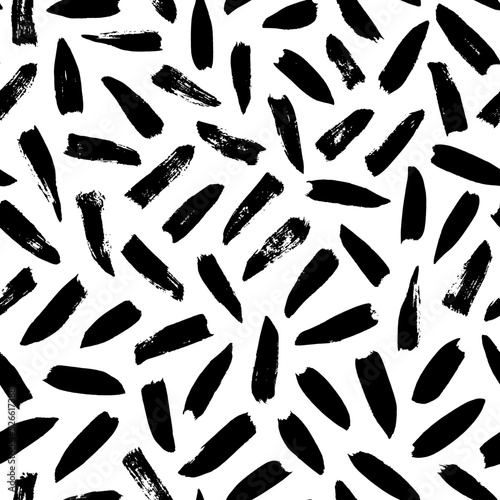 Seamless pattern with irregular black dashes. Simple geometric texture with short brushstrokes. Abstract background in Memphis style. Ink painted hand made texture. Vector black ink ornament.