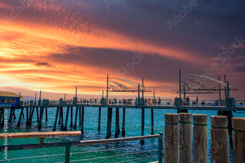 Принти на полотні a gorgeous summer landscape at the pier with deep blue ocean water and people wa