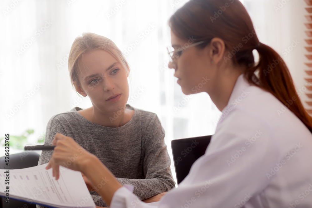 Young woman doctor talking and discussion with patient about disease and illness for diagnostic at clinic, physician explaining and consultation about sick and looking document, medical concept. Young woman doctor talking and discussion with patient about disease and illness for diagnostic at clinic, physician explaining and consultation about sick and looking document, medical concept.