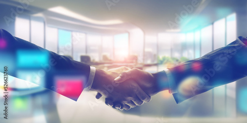Businessmen shaking hands and technology concept. Wide image for banners, advertisements.