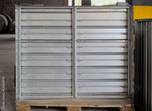 A motorized fire damper is being prepared for packing inside a workshop.	