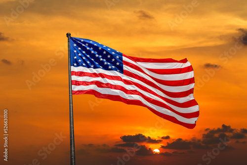 USA flag waving against sunset sky