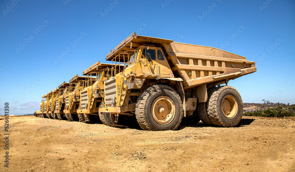 Large dump trucks in a row at a construction site 007 Large dump trucks in a row at a construction site 007