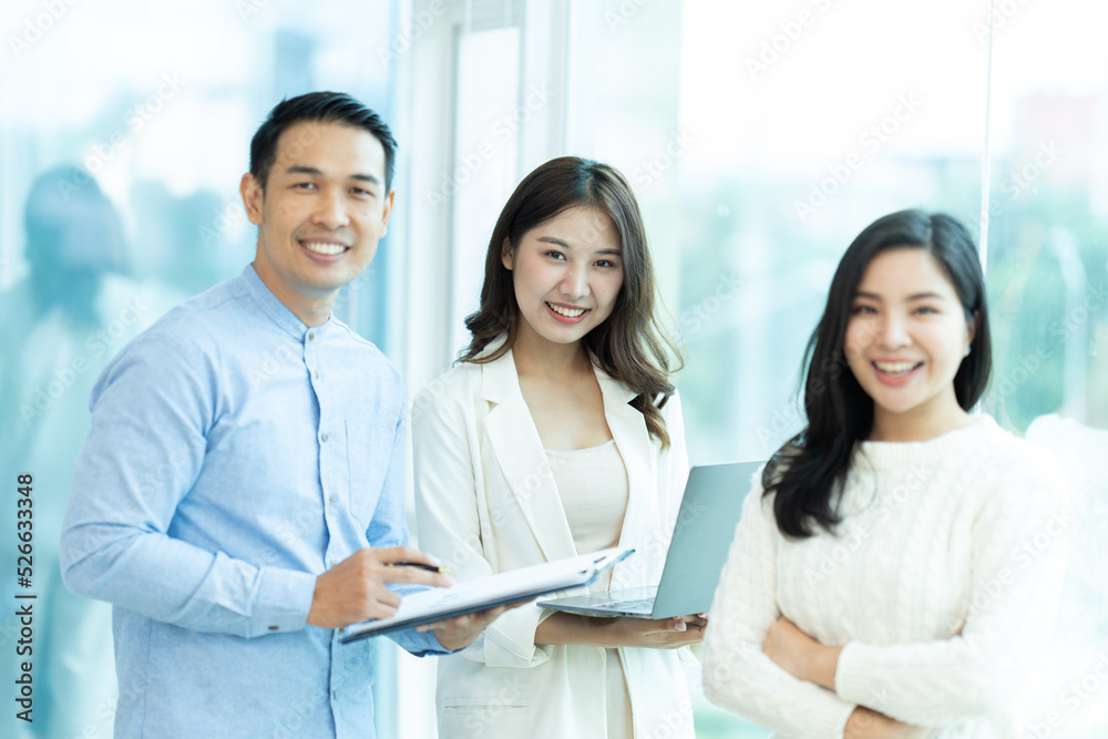 Business people showing team work while working in board room in office interior. People helping one of their colleague to finish new business plan. Business concept. Team work. Business people showing team work while working in board room in office interior. People helping one of their colleague to finish new business plan. Business concept. Team work.