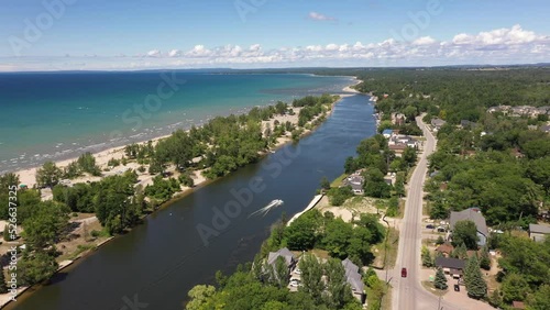 Jet Ski in wasaga beach coastline with blue waters and boats and people on beach photo