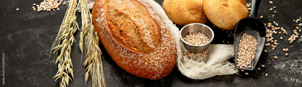 Bread assortment on dark background. Stock Photo | Adobe Stock