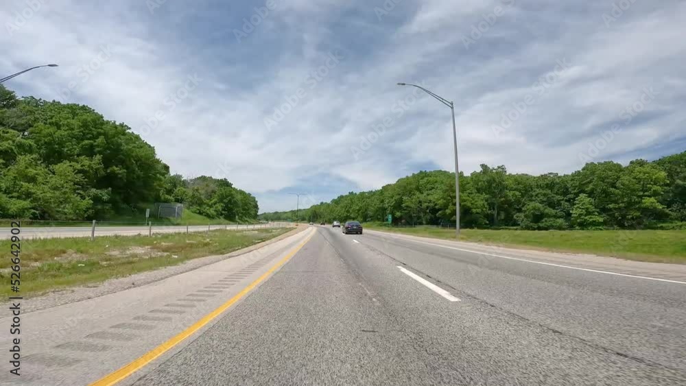 POV driving on Interstate 280 around the south side of the Quad Cities of Illinois; divided highway surrounded by trees and follows the Rock River; with little traffic on a sunny day POV driving on Interstate 280 around the south side of the Quad Cities of Illinois; divided highway surrounded by trees and follows the Rock River; with little traffic on a sunny day