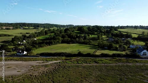 Aerial rising view Traeth Coch Pentraeth Welsh rural marshland scenic farming countryside at sunset photo